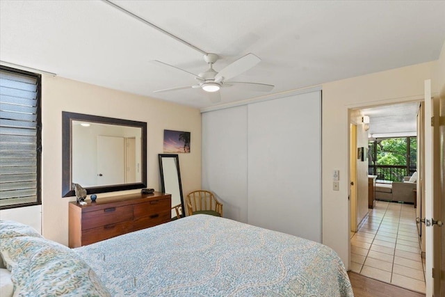 bedroom with a closet, wood-type flooring, and ceiling fan