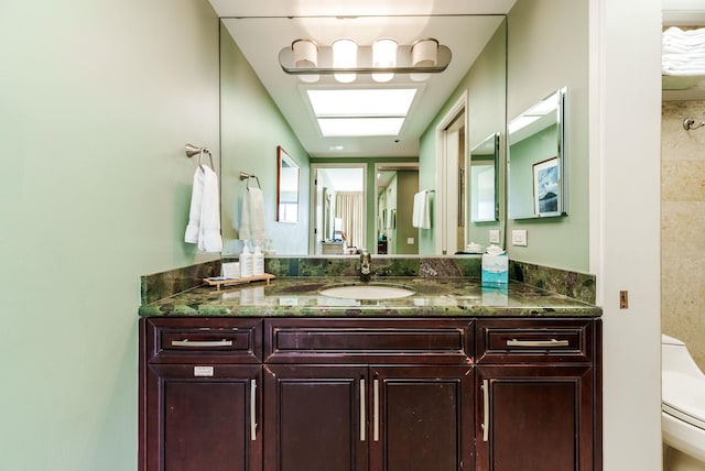 bathroom featuring oversized vanity and toilet