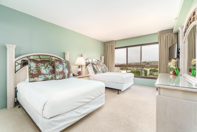 bedroom featuring light carpet