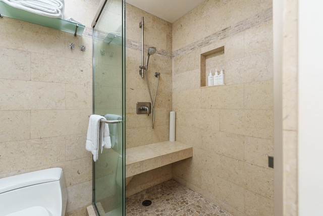 bathroom featuring toilet and walk in shower