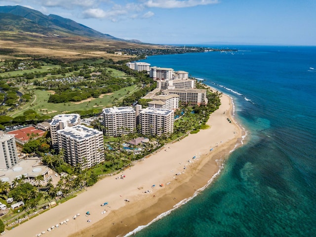 bird's eye view featuring a water and mountain view and a beach view