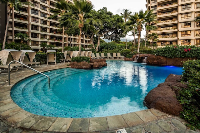 view of swimming pool with pool water feature