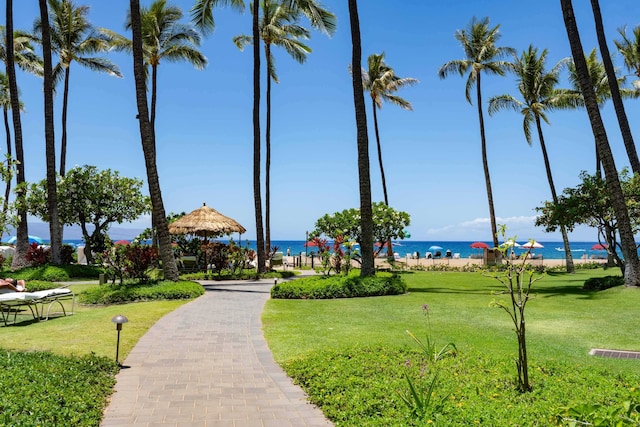 surrounding community featuring a lawn and a water view