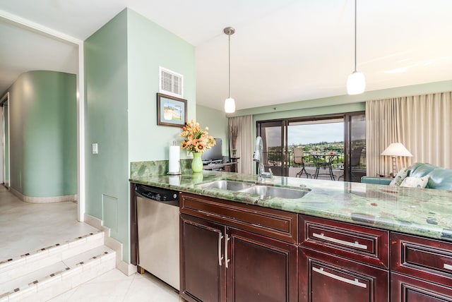 kitchen featuring light stone counters, sink, pendant lighting, and stainless steel dishwasher