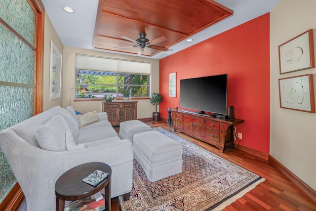 living room featuring hardwood / wood-style floors and ceiling fan