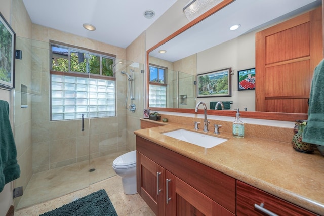 bathroom featuring vanity, toilet, and a shower with shower door