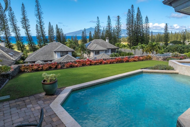 view of pool with a lawn, a mountain view, and a patio