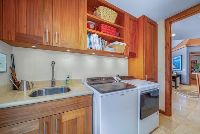 clothes washing area featuring cabinets, independent washer and dryer, and sink