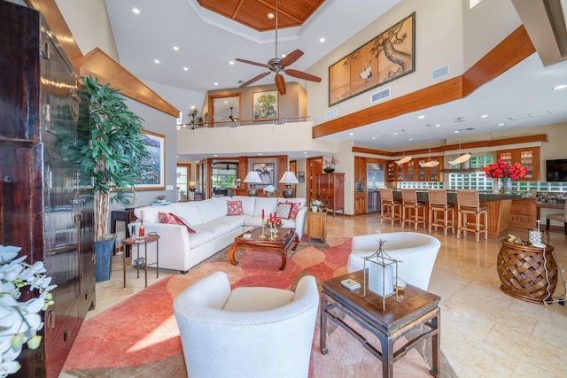 living room with a high ceiling and ceiling fan