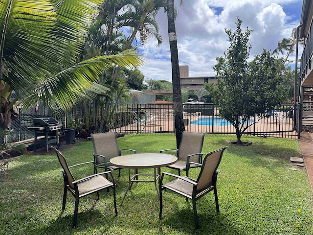 view of yard featuring a fenced in pool and a patio