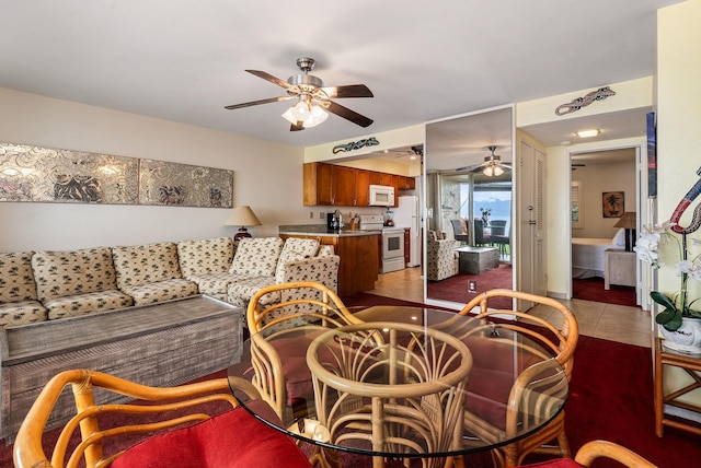 living room featuring ceiling fan and light tile patterned floors