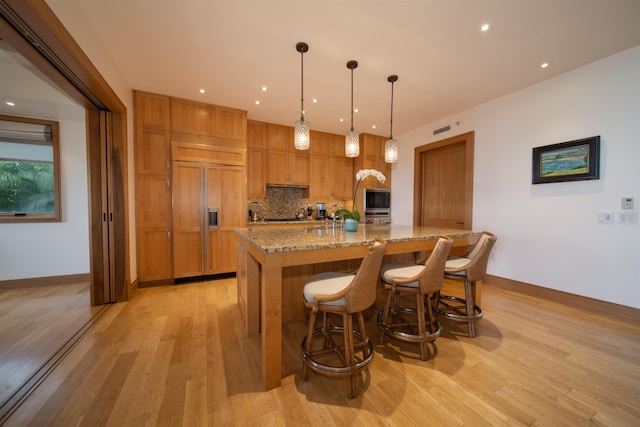 1 Bay Dr Unit 1204, Lahaina, HI 96761 - kitchen with built in appliances, baseboards, light wood-type flooring, backsplash, and recessed lighting