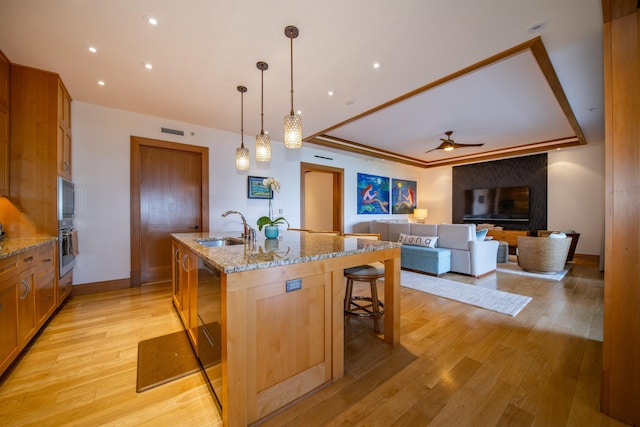 1 Bay Dr Unit 1204, Lahaina, HI 96761 - kitchen featuring a sink, oven, ceiling fan, a center island with sink, and light wood-type flooring