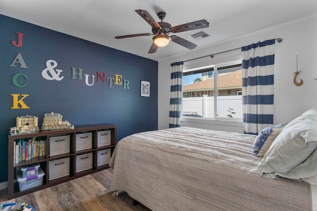 bedroom featuring hardwood / wood-style floors and ceiling fan