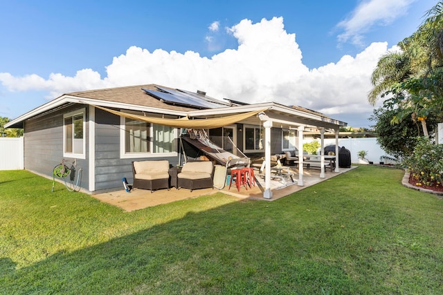 back of house featuring an outdoor hangout area, solar panels, a lawn, and a patio area