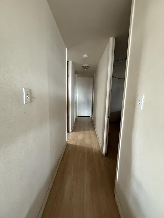 hallway with light wood-type flooring