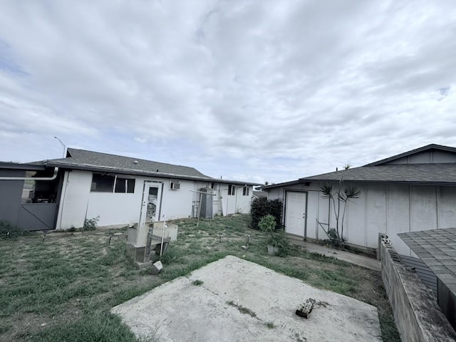 back of house featuring a yard and a patio