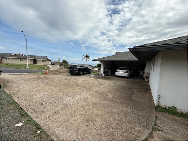 view of vehicle parking with a carport