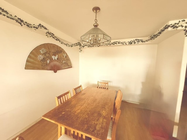 dining room featuring an inviting chandelier and hardwood / wood-style flooring