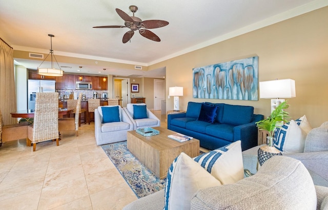 living room featuring crown molding, ceiling fan, and light tile patterned floors