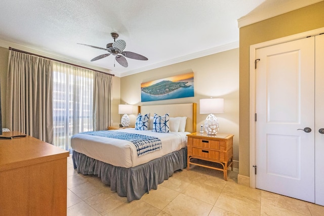 tiled bedroom with a textured ceiling, crown molding, and ceiling fan