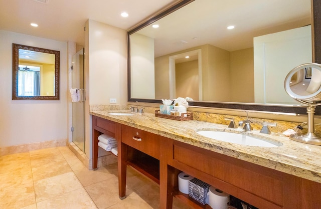 bathroom with dual vanity, an enclosed shower, and tile patterned flooring