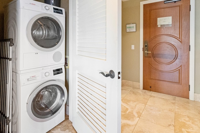 washroom with stacked washer and clothes dryer and tile patterned floors