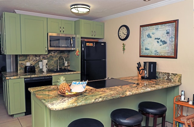 kitchen featuring black appliances, kitchen peninsula, sink, and green cabinets