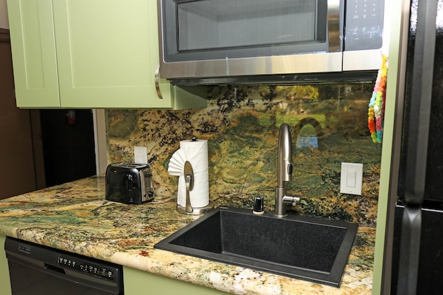 kitchen with green cabinets, dishwasher, tasteful backsplash, and sink