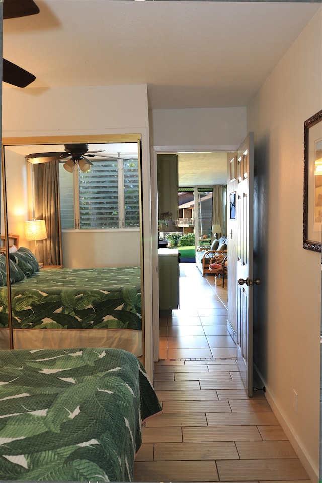 bedroom with ceiling fan and wood-type flooring