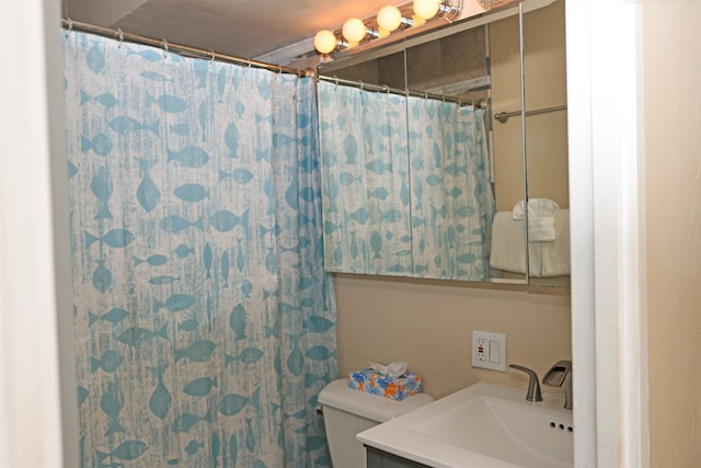 bathroom featuring a shower with curtain, toilet, and vanity