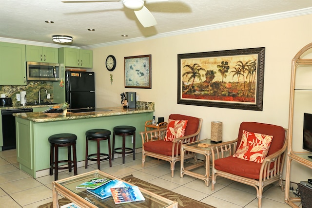 kitchen featuring black appliances, light tile patterned flooring, green cabinets, and ceiling fan