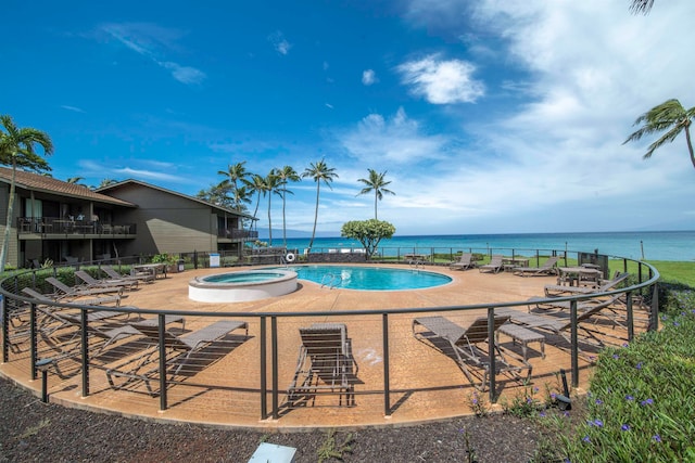 view of pool with a water view and a community hot tub