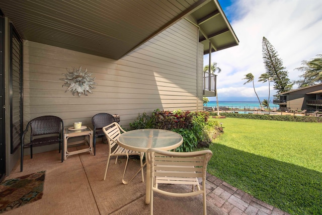 view of patio with a water view