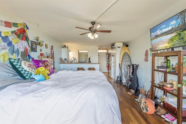 bedroom with dark hardwood / wood-style floors and ceiling fan