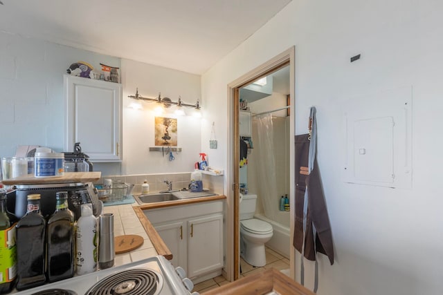 full bathroom with tile patterned flooring, electric panel, toilet, shower / tub combo with curtain, and vanity