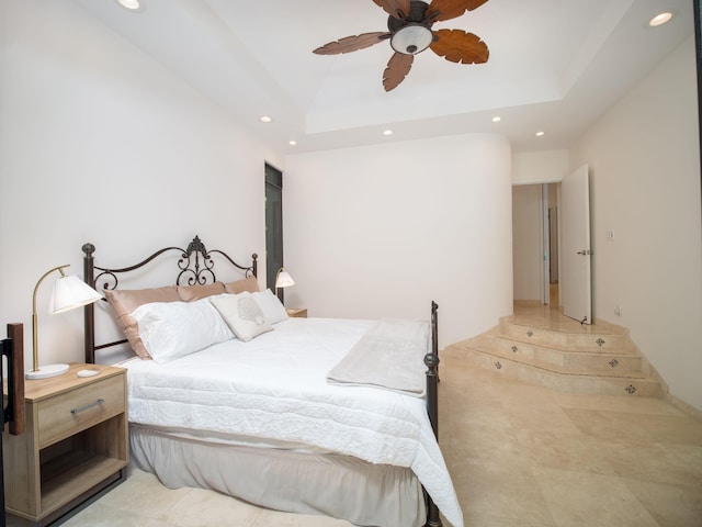 bedroom featuring a tray ceiling and ceiling fan