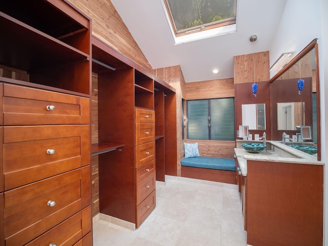 spacious closet with sink and vaulted ceiling