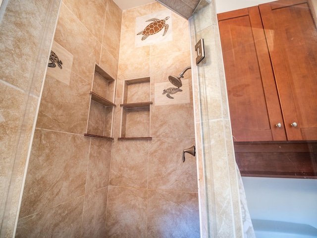 bathroom with a tile shower