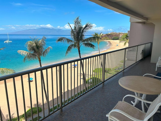 balcony with a water and mountain view and a beach view