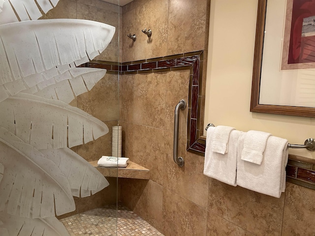 bathroom with a tile shower