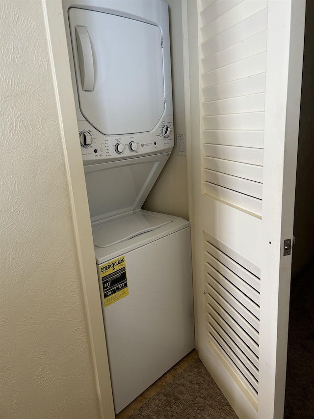 laundry room with stacked washer / drying machine