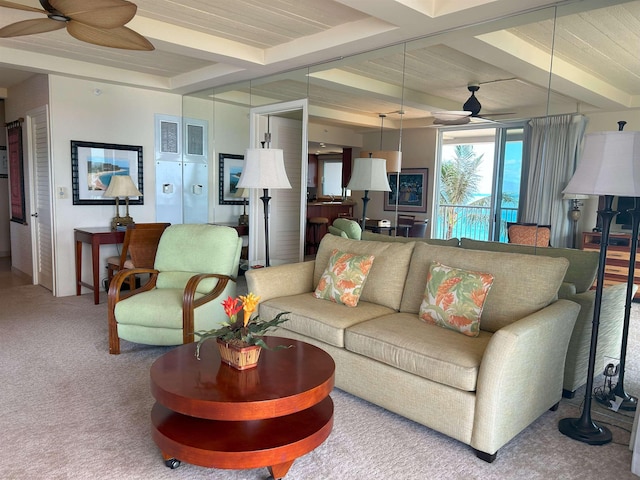 living room featuring ceiling fan, carpet floors, and beamed ceiling