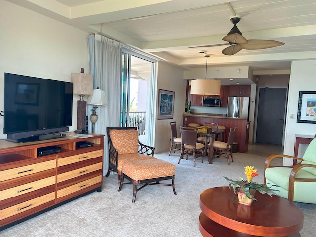 carpeted living room with beam ceiling and ceiling fan