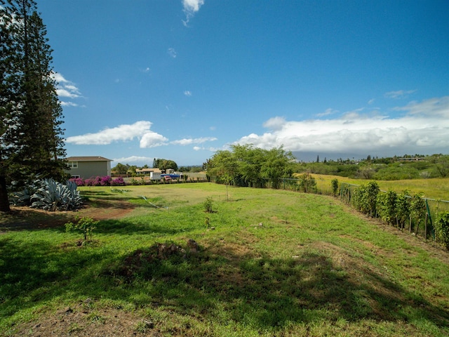 view of yard featuring a rural view and fence