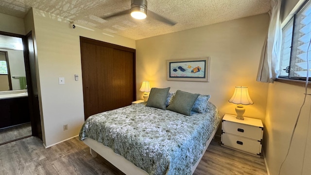 bedroom featuring wood-type flooring, ceiling fan, a textured ceiling, and a closet