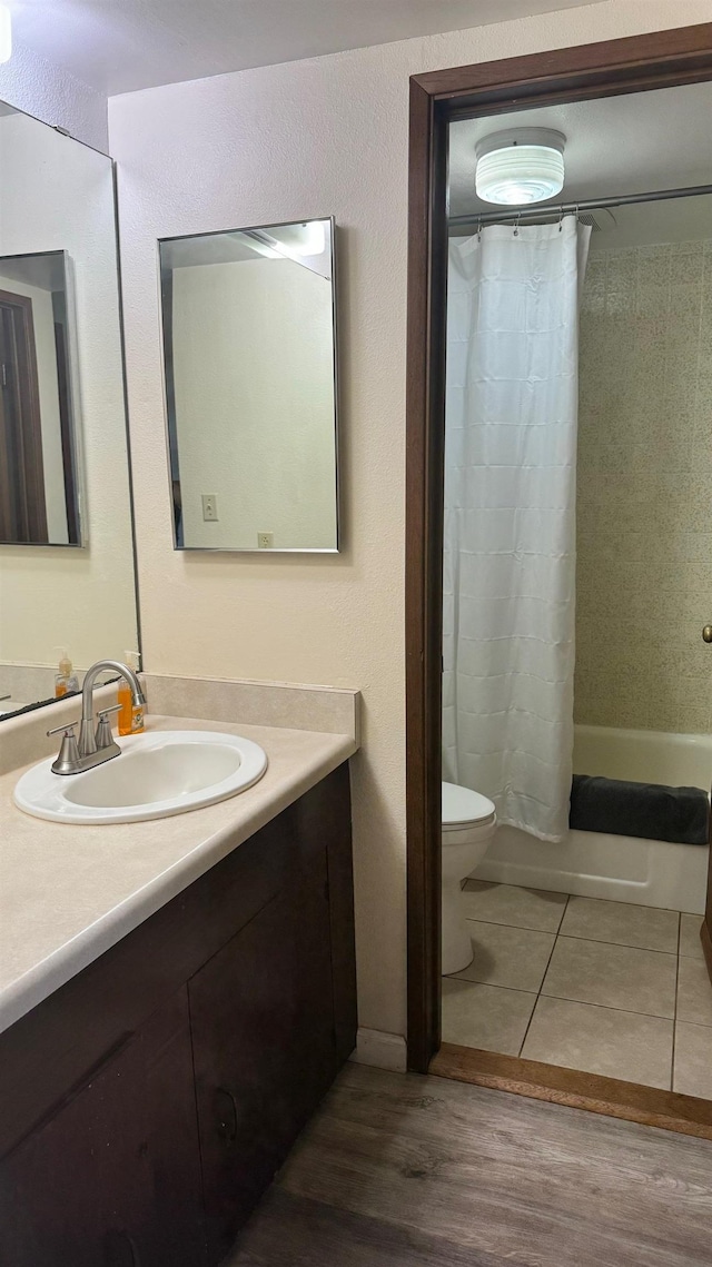 full bathroom featuring shower / tub combo with curtain, vanity, toilet, and tile patterned flooring