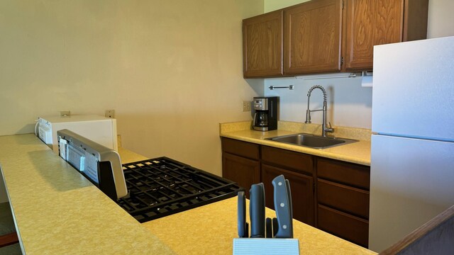 kitchen featuring sink and white refrigerator