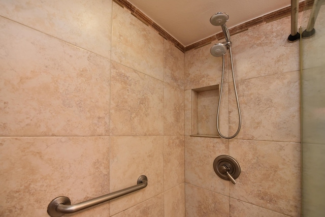 details featuring ornamental molding and tiled shower