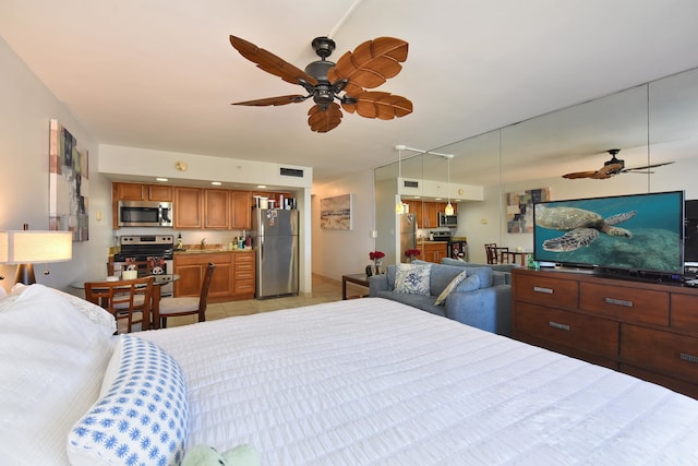 bedroom with ceiling fan and stainless steel refrigerator